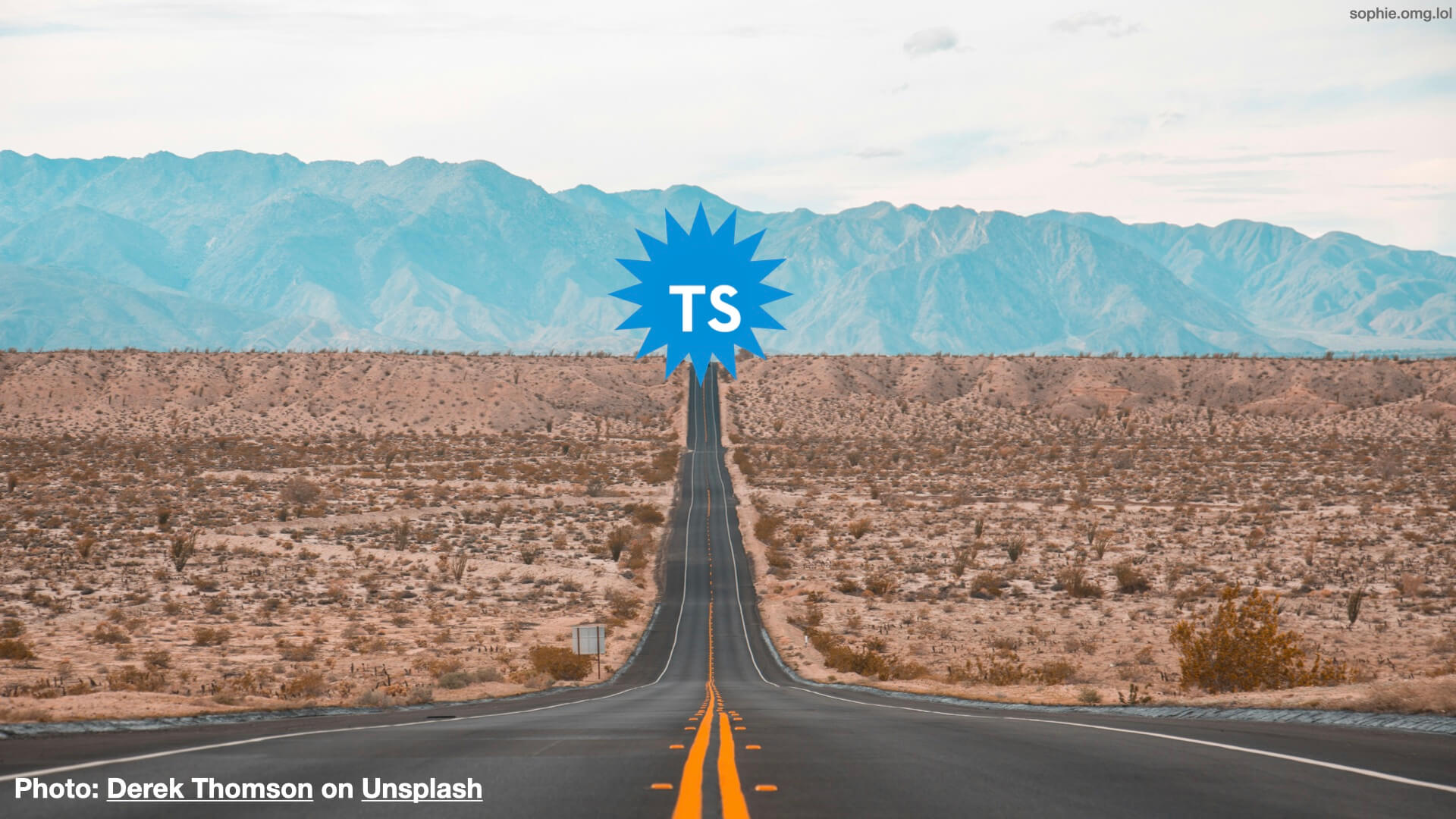 A photo of a long road in the desert travelling up the centre of the slide. At the end is a star-shaped Typescript logo.